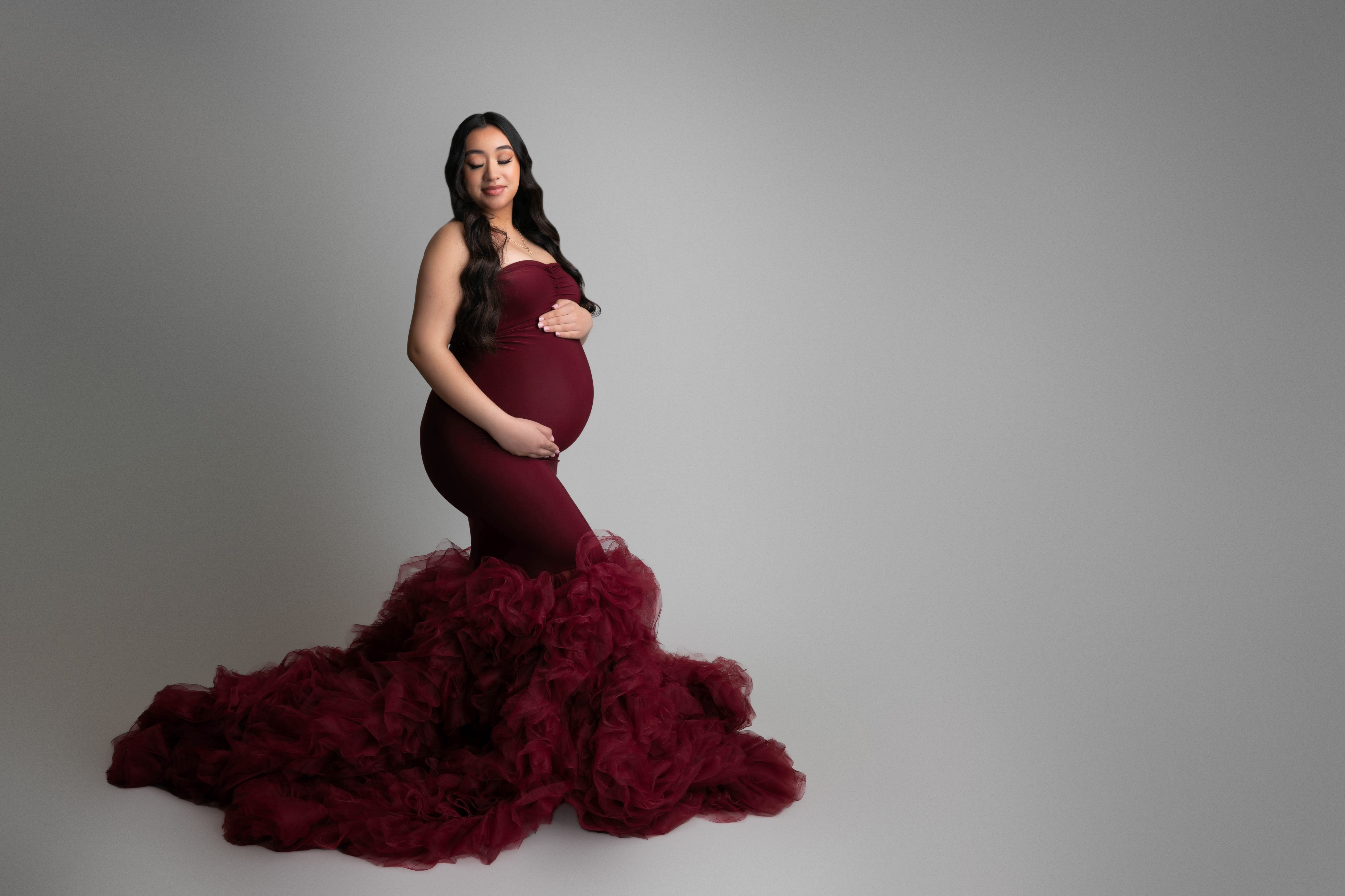 woman in red gown for her bluffton maternity pictures