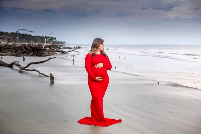 Pregnant mother on a stormy beach on Hunting Island state park, South Carolina